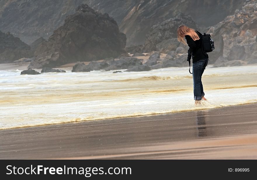 Barefoot girl walking in the water. Barefoot girl walking in the water