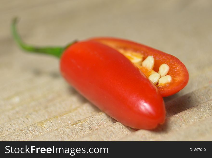 Red chili on textured surface. Red chili on textured surface