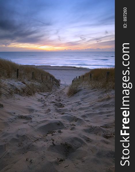 Path through the dunes to the ocean at sunset. Path through the dunes to the ocean at sunset