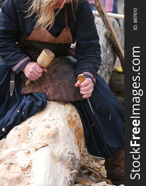 A craftsman working wood the oldfashioned way, thinking about what is best to do next. A craftsman working wood the oldfashioned way, thinking about what is best to do next