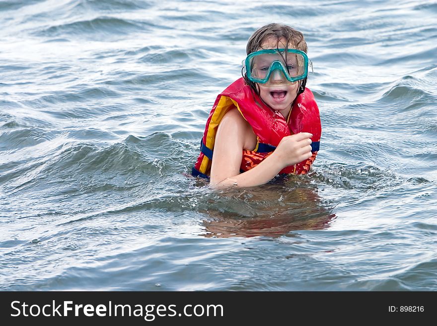 Young girl with swim goggles suprised by what she saw. Young girl with swim goggles suprised by what she saw