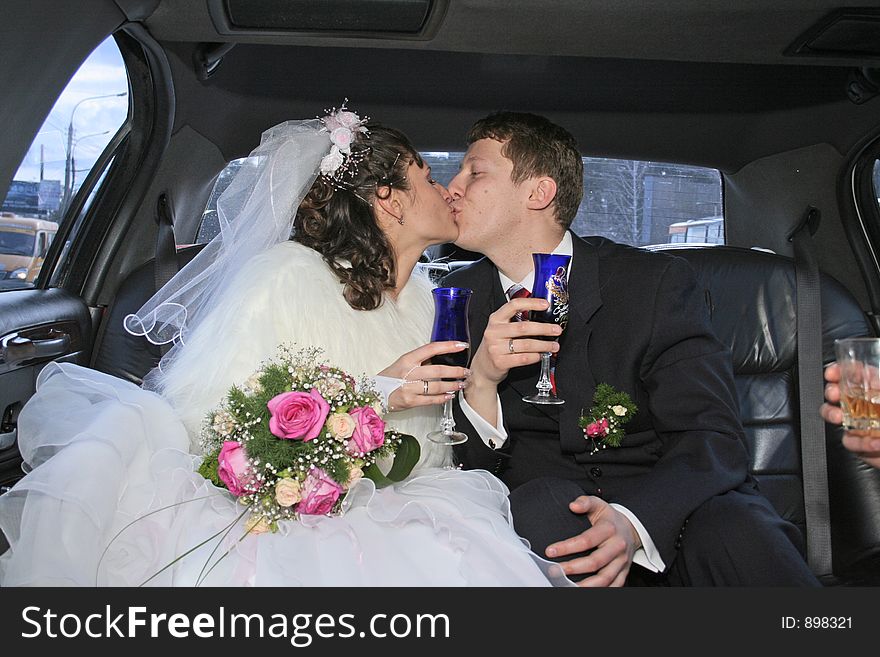 Newlywedses are kissed in machine. Newlywedses are kissed in machine