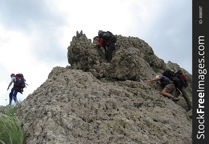 Three climbers about stone