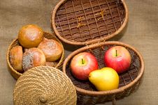 Baskets With Rolls And Fruits Stock Photos