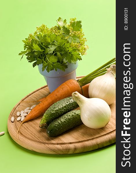 Vegeterian food, fresh vegetables: onion, carrot, cucumber and parsley