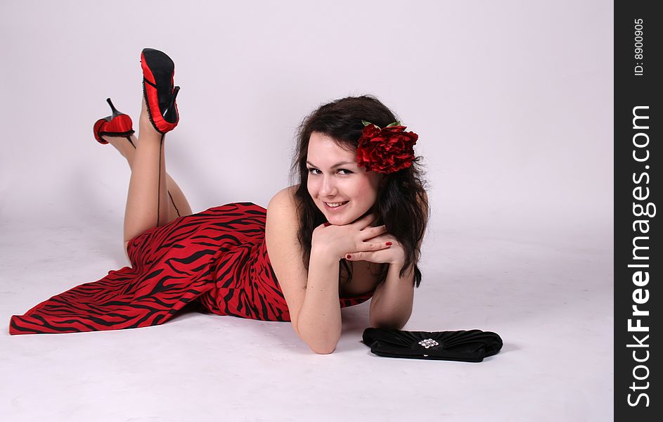 Smiling pinup girl lying in studio