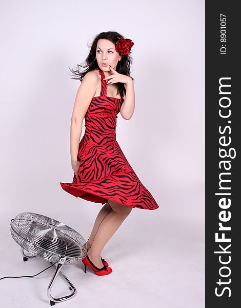 pinup girl standing near ventilator in studio. pinup girl standing near ventilator in studio