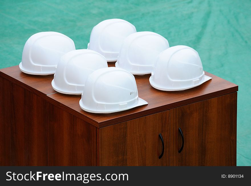 Helmets of builders lie on a bedside table. Helmets of builders lie on a bedside table.