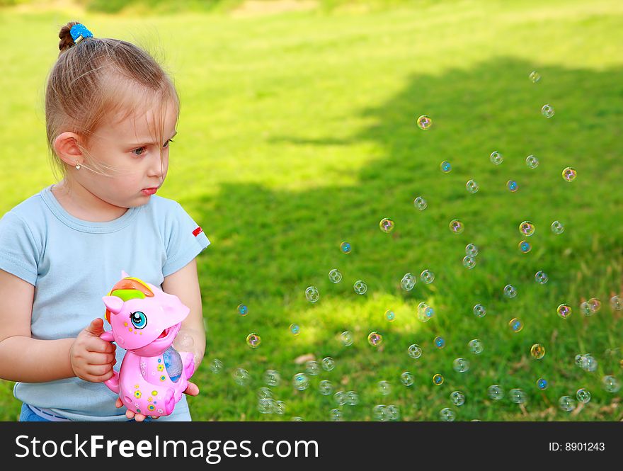 Little girl playing with bubble