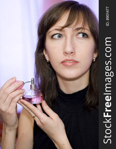 Woman with bottle of perfume