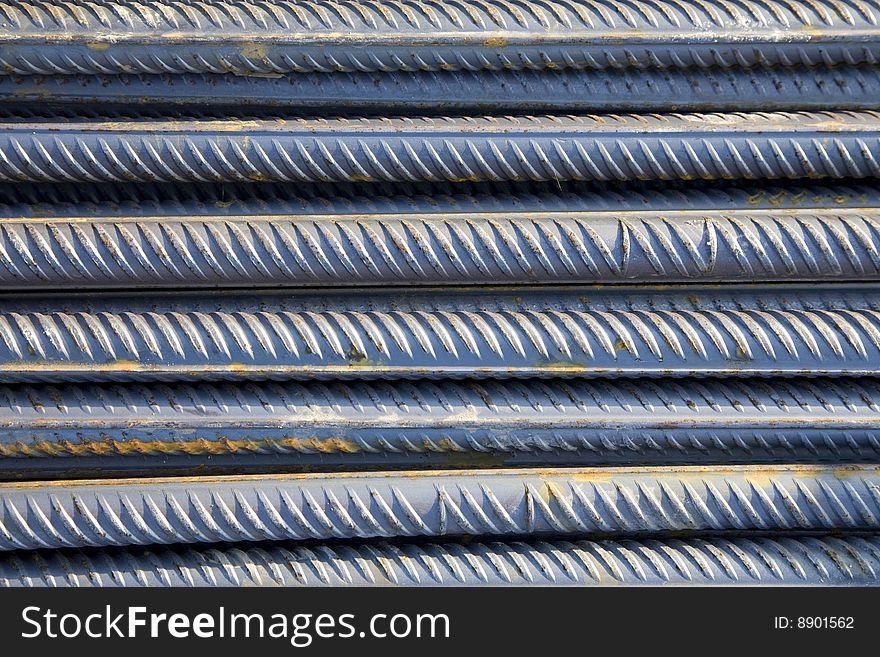 Stack of metal rods as an industrial background design