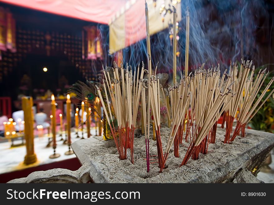 Joss sticks burn at an altar in temple