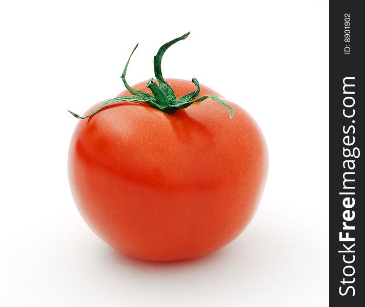 Ripe big red tomato on a white background