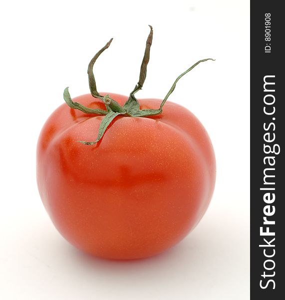 Ripe big red tomato on a white background