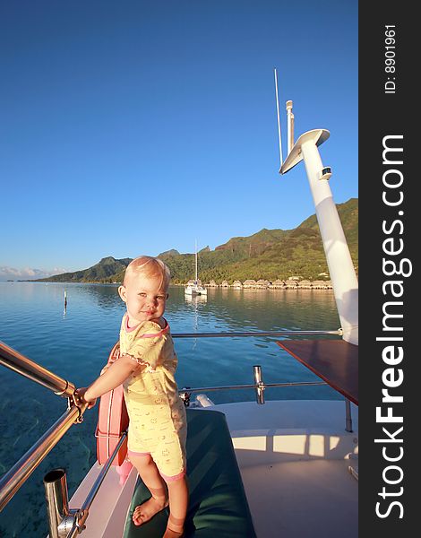 Child on a motor boat at anchor. Child on a motor boat at anchor