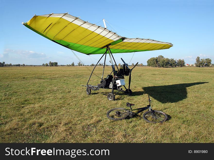 Microplight before flight and bicycle nearby. Microplight before flight and bicycle nearby