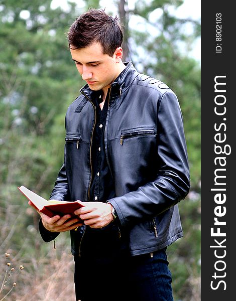 Young Businessman and Notebook, shot outdoor.