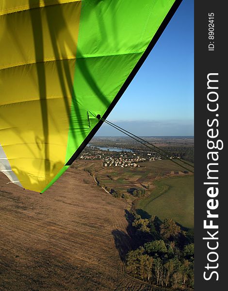Green and yellow microlight inthe sky. Green and yellow microlight inthe sky