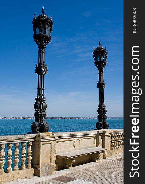 Ornamental Cast Iron Lamp Posts against bright sky in Cadiz, Spain. Ornamental Cast Iron Lamp Posts against bright sky in Cadiz, Spain