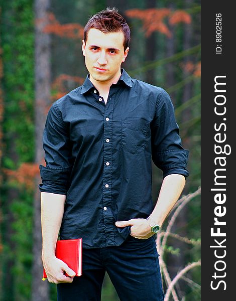 Young Businessman and Notebook, shot outdoors.