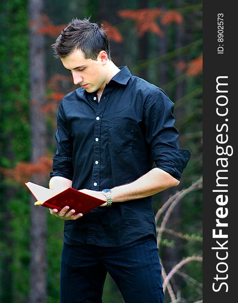 Young Businessman and Notebook, shot outdoors.