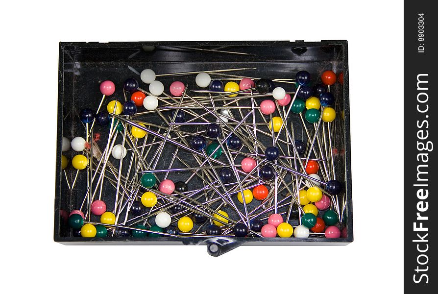 A box of colored straight pins for sewing