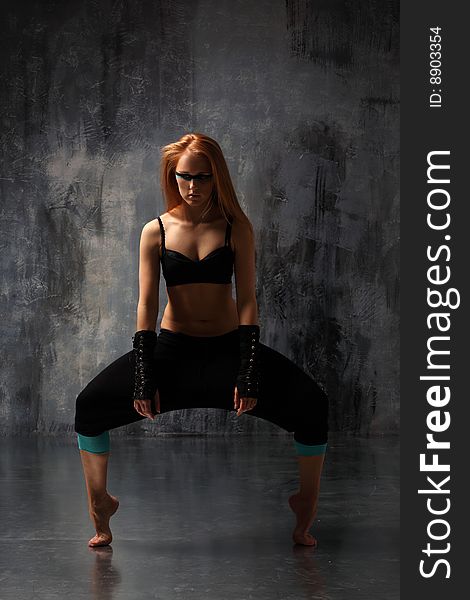 Modern style dancer posing behind studio background. Modern style dancer posing behind studio background