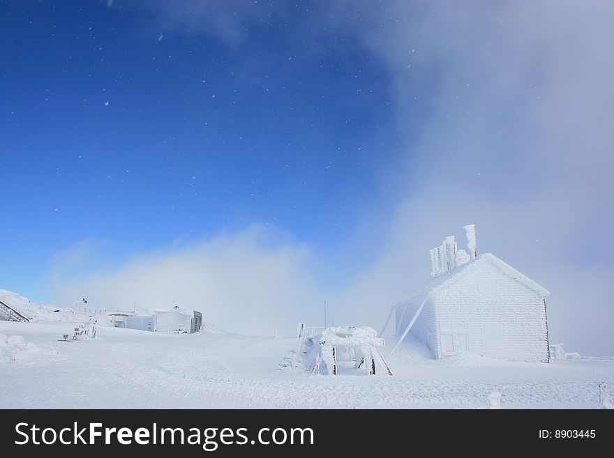 Snow flakes falling in a blue sky without any clouds at Mount Washington. Snow flakes falling in a blue sky without any clouds at Mount Washington