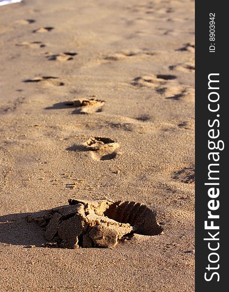 Trace of a foots of the person on sea sand. Trace of a foots of the person on sea sand