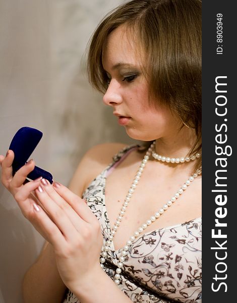 Girl holds the blue sheath with a ring. Girl holds the blue sheath with a ring