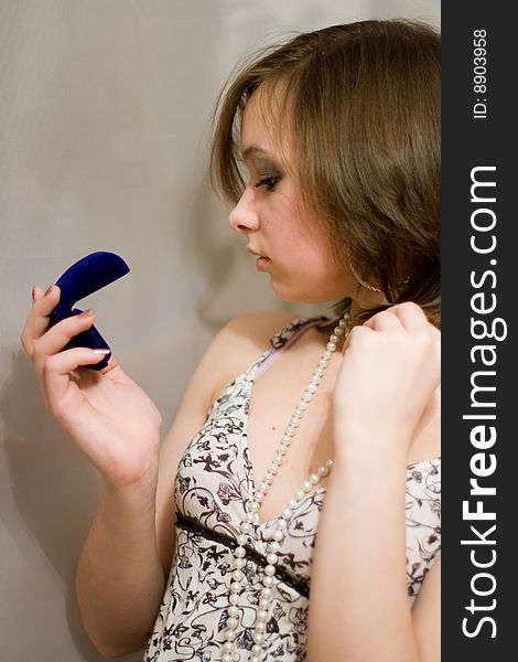 Girl holds the blue sheath with a ring. Girl holds the blue sheath with a ring