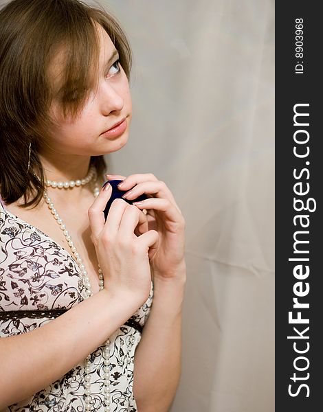 Girl holds the blue sheath with a ring. Girl holds the blue sheath with a ring