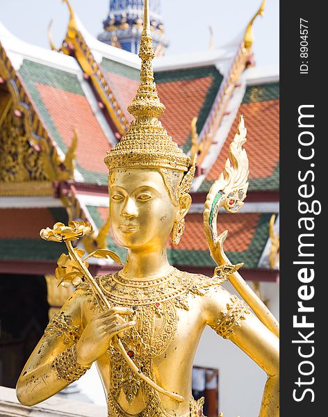 Mythic creature Kinnara golden statue at the Wat Phra Kaeo (Temple of Emerald Buddha), Bangkok, Thailand