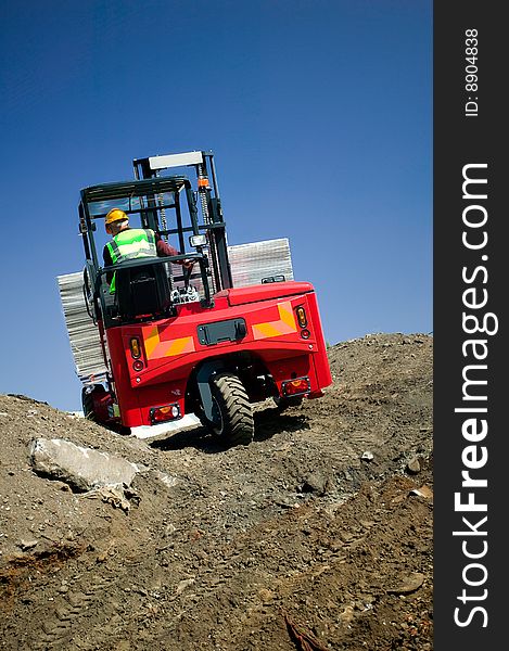 Portable Forklift Offloading Shipment down rough terrain. Portable Forklift Offloading Shipment down rough terrain