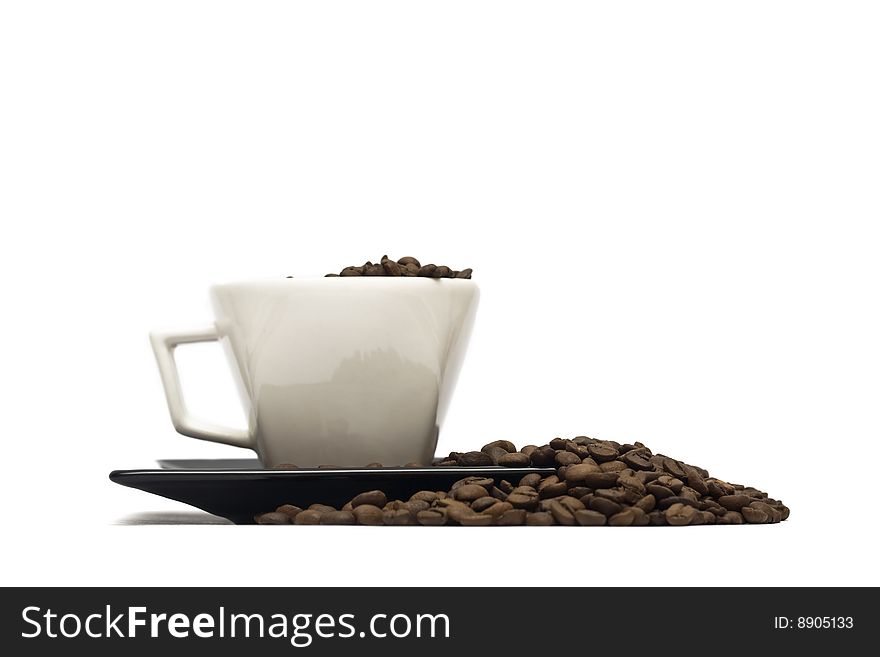 A lovely set of a coffee mug and coffee beads, isolated on a white background.