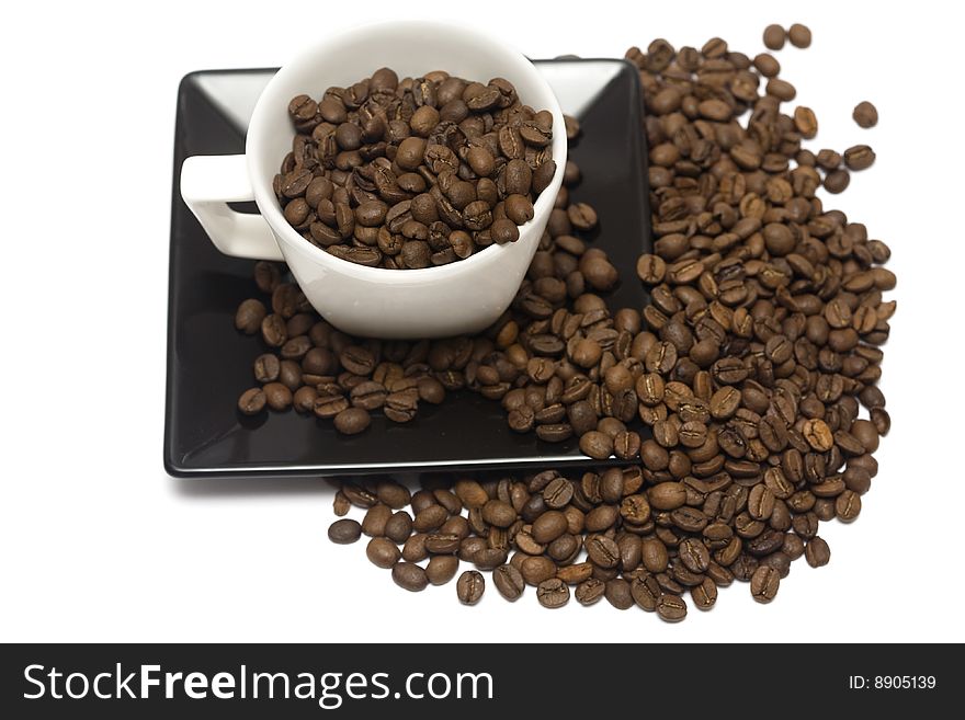 A lovely set of a coffee mug and coffee beads, isolated on a white background.