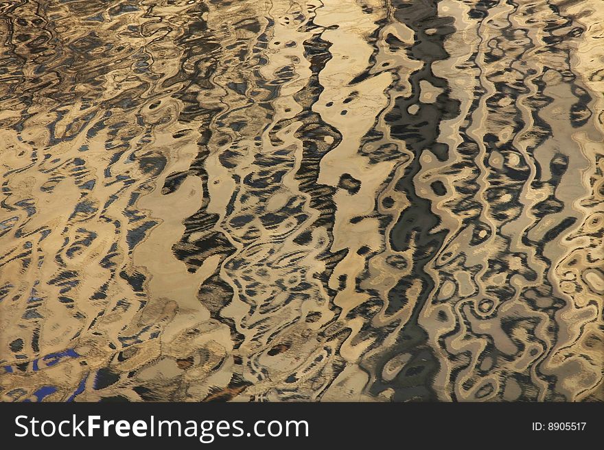 Reflection of a multistory building from a surface of the river.