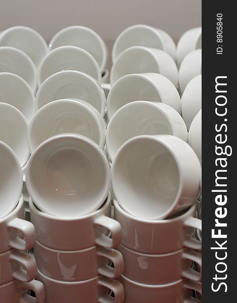 Neatly arranged white coffee cups