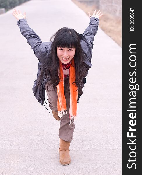 Chinese young girl standing in the flying pose