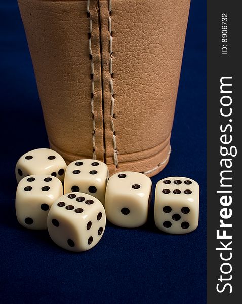 Dice cup and dice on background