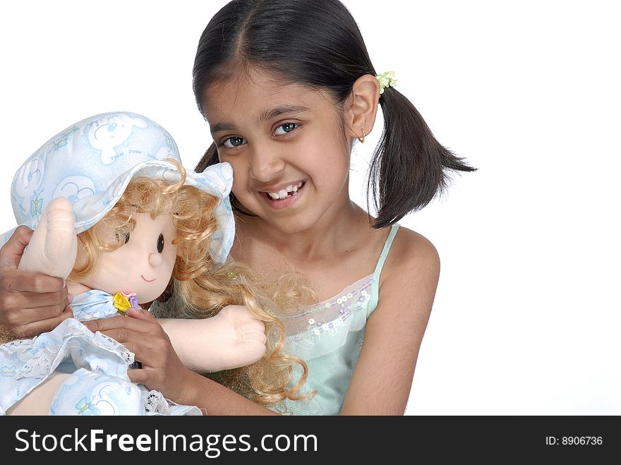 Cute girl holding pretty doll