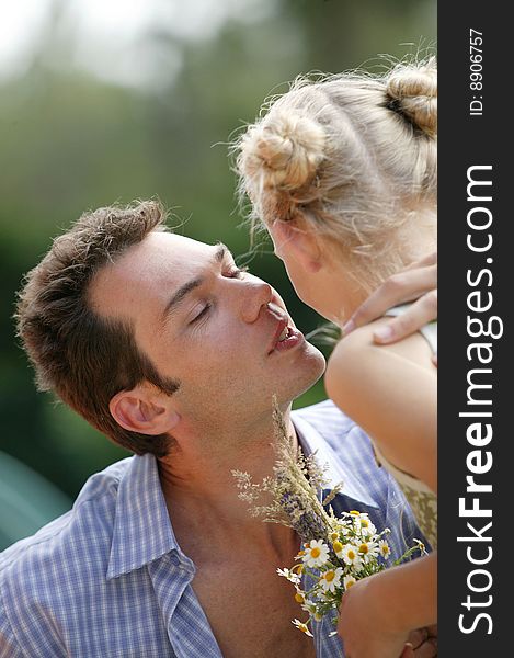 Young man kissing little girl