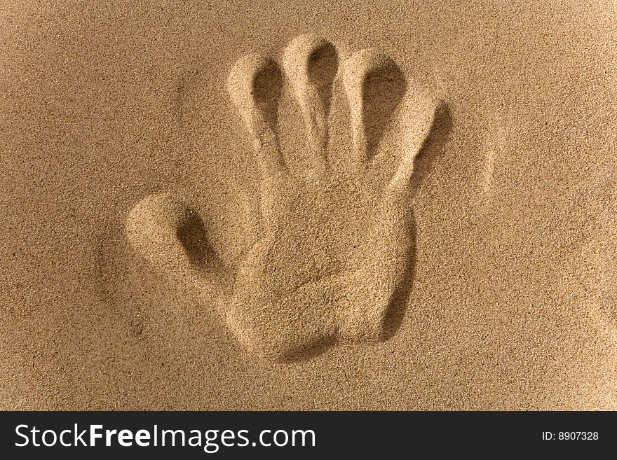 Close-up of hand imprints in sand