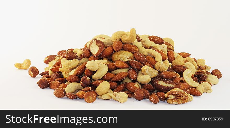 Deluxe, salted, mixed nuts in a pile ready for eating. Deluxe, salted, mixed nuts in a pile ready for eating