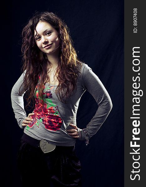 Portrait of a young dark-haired girl in the black background. Portrait of a young dark-haired girl in the black background