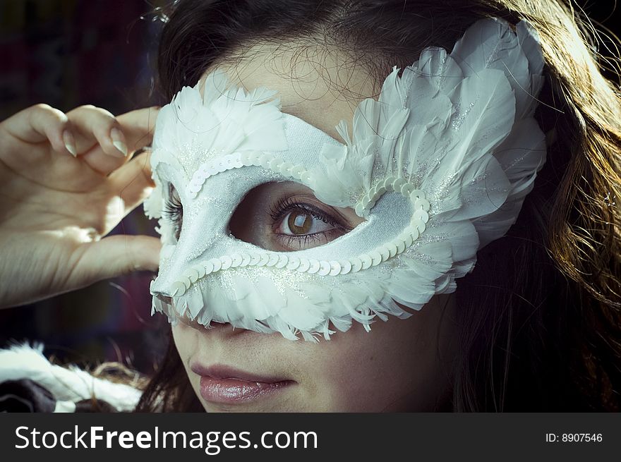 Studio portrait of a girl in a mask