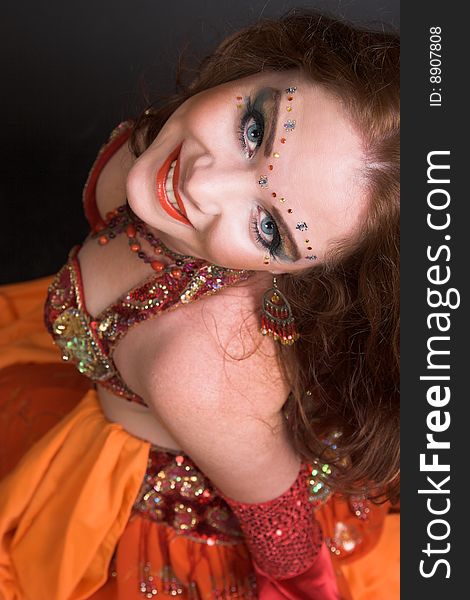 Belly Dancer wearing a red costume with jewelery. Belly Dancer wearing a red costume with jewelery