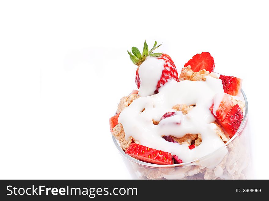 Bowl with corn flakes and strawberry served on glass