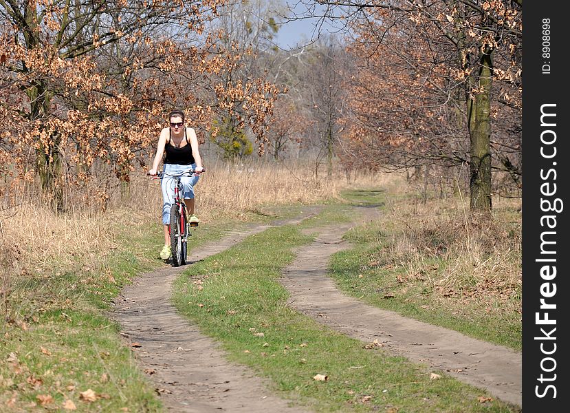 Girl riding a bike in beautiful spring scenery. Girl riding a bike in beautiful spring scenery