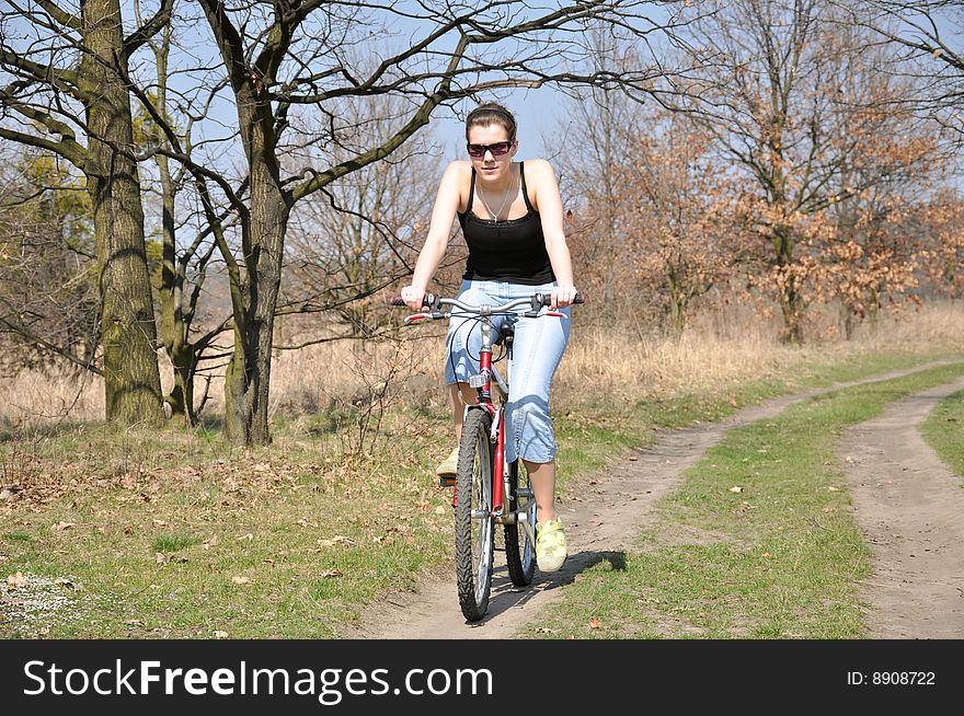 Girl riding a bike in spring scenery. Girl riding a bike in spring scenery